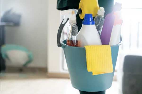 6 dicas para te ajudar na faxina em dias frios. um balde com diversos produtos de limpeza dentro.
